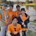A group of Curtin Volunteers in front of a lake.
