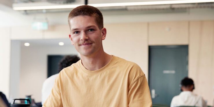 Student in the library smiling