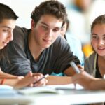Group of high school students studying together around a table.