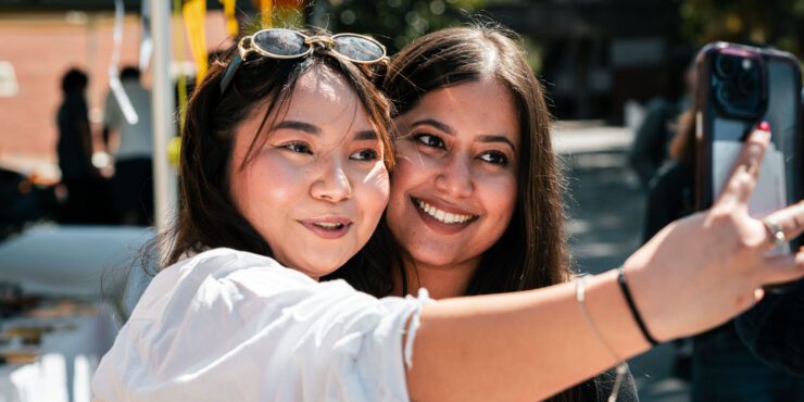 Devna taking a photo with a fan.