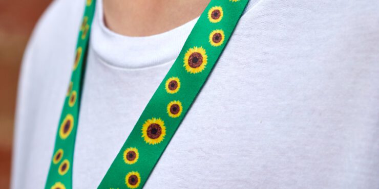 Person with sunflower lanyard