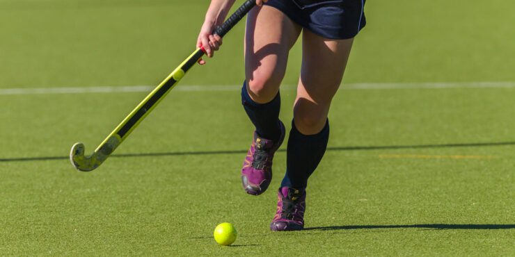A hockey field with a player.