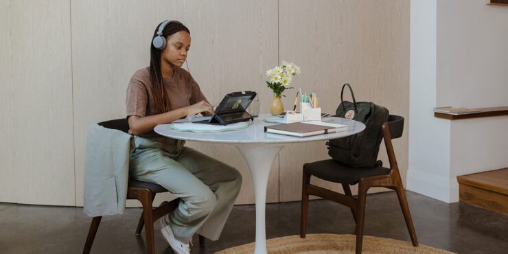 A student studying at home on her laptop.