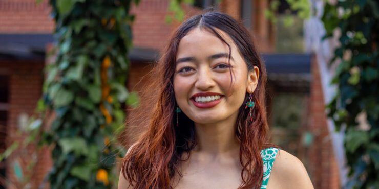 Biji, a Curtin Marketing student smiles on campus.