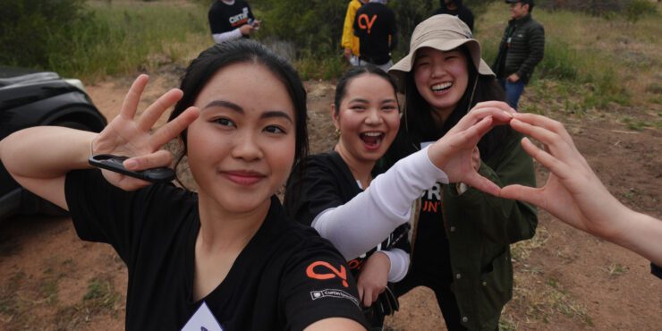 Celena, Devna and a volunteer smiling for the camera.