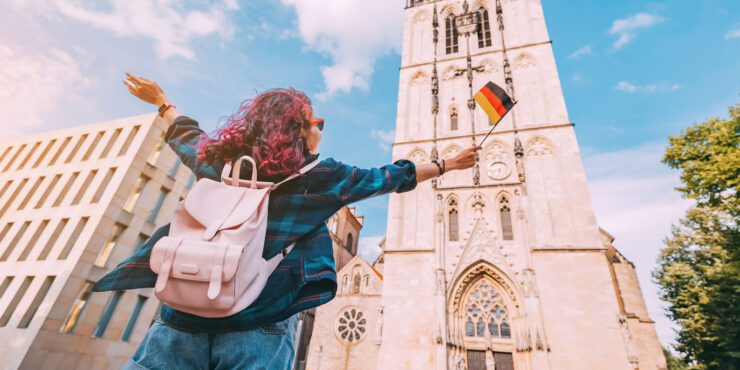 A student standing in front of a European building.