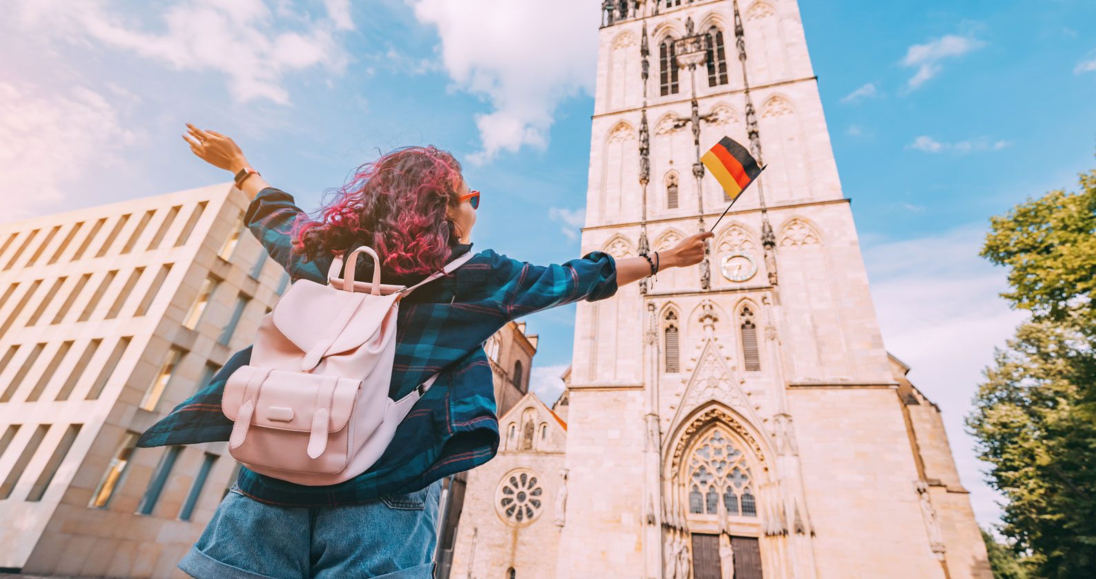 A student standing in front of a European building.