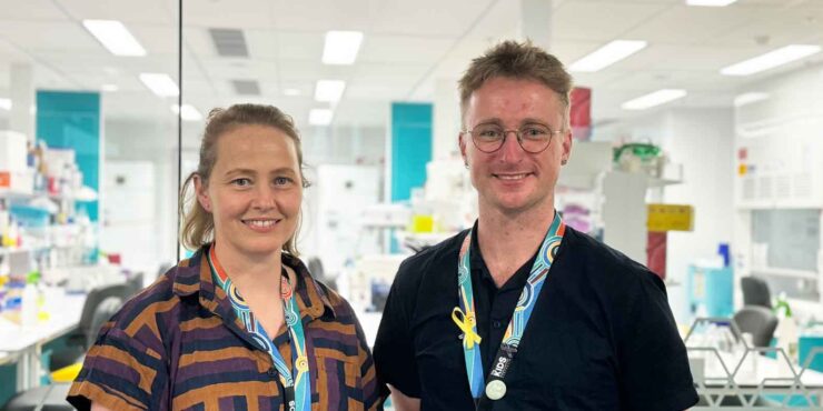 Mike and Shannon stand in front of a lab.