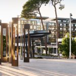 A photo of buildings and an art installation on the Curtin Perh campus at sunset.