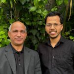 Hussein and Alam smile at the camera.