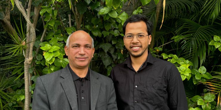 Hussein and Alam smile at the camera.