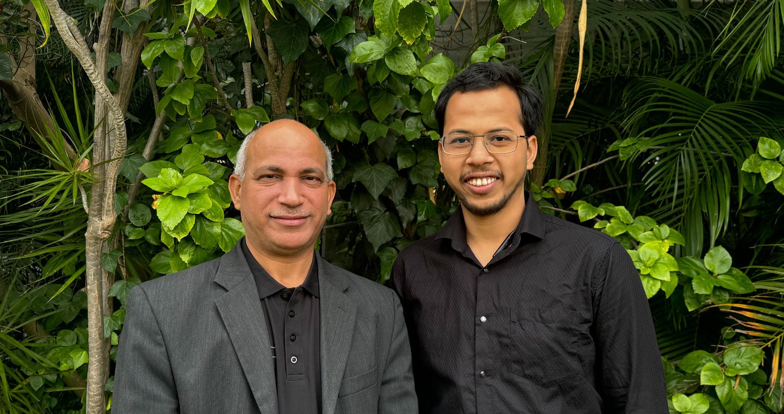 Hussein and Alam smile at the camera.