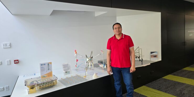 An image of Essam in front of an exhibition.