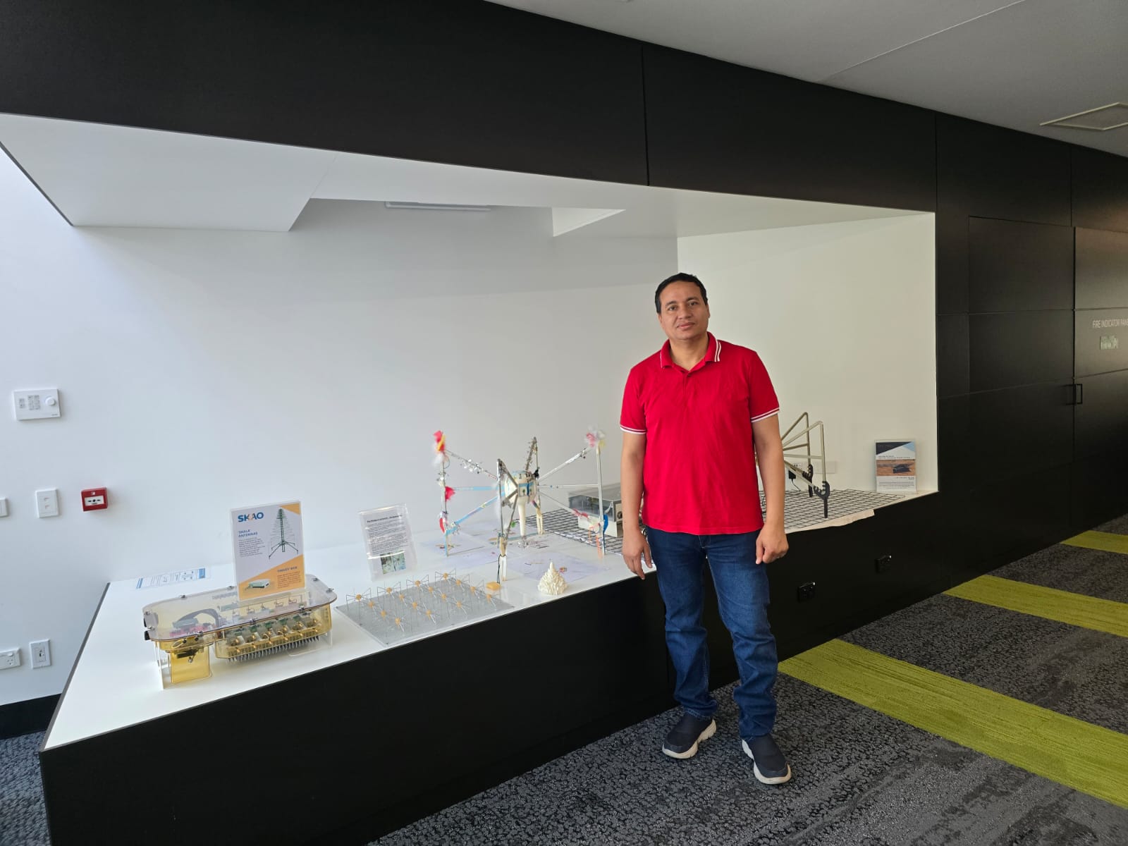 An image of Essam in front of an exhibition.