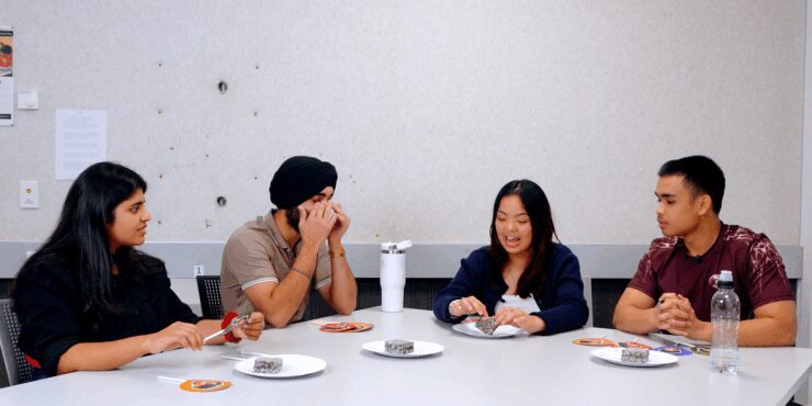 The hosts discussing the lamington in front of them