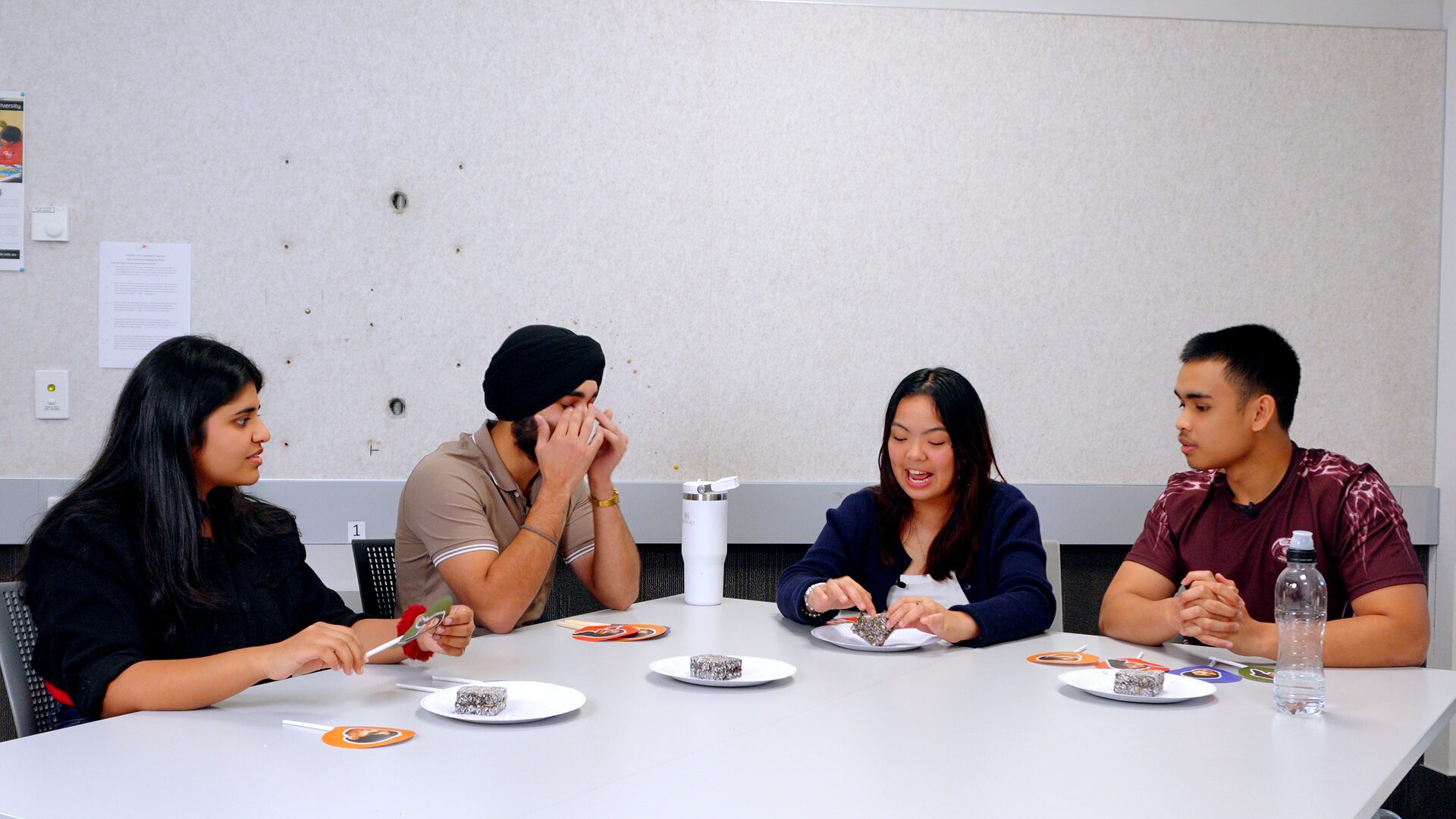 The hosts discussing the lamington in front of them