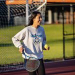 Curtin student playing tennis.