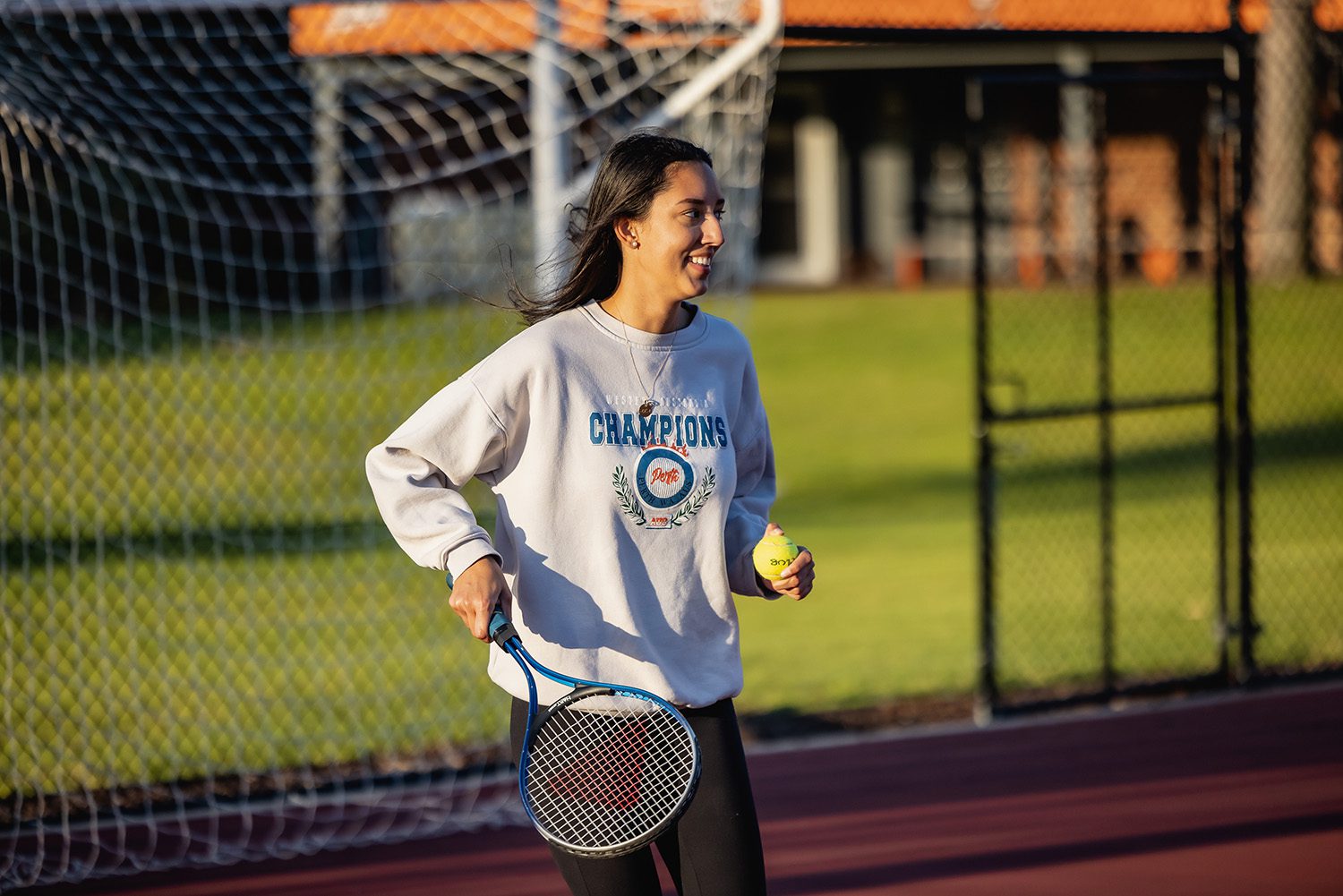 Curtin student playing tennis.