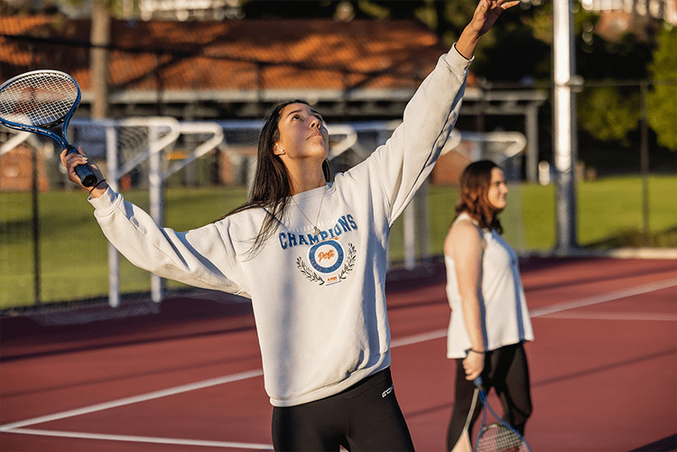 Student plays tennis.