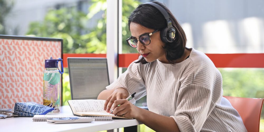 student with headphones studying.