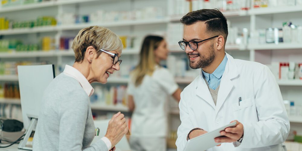 Pharmcist shows customer their prescription