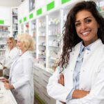 Female pharmacist smiles at camera