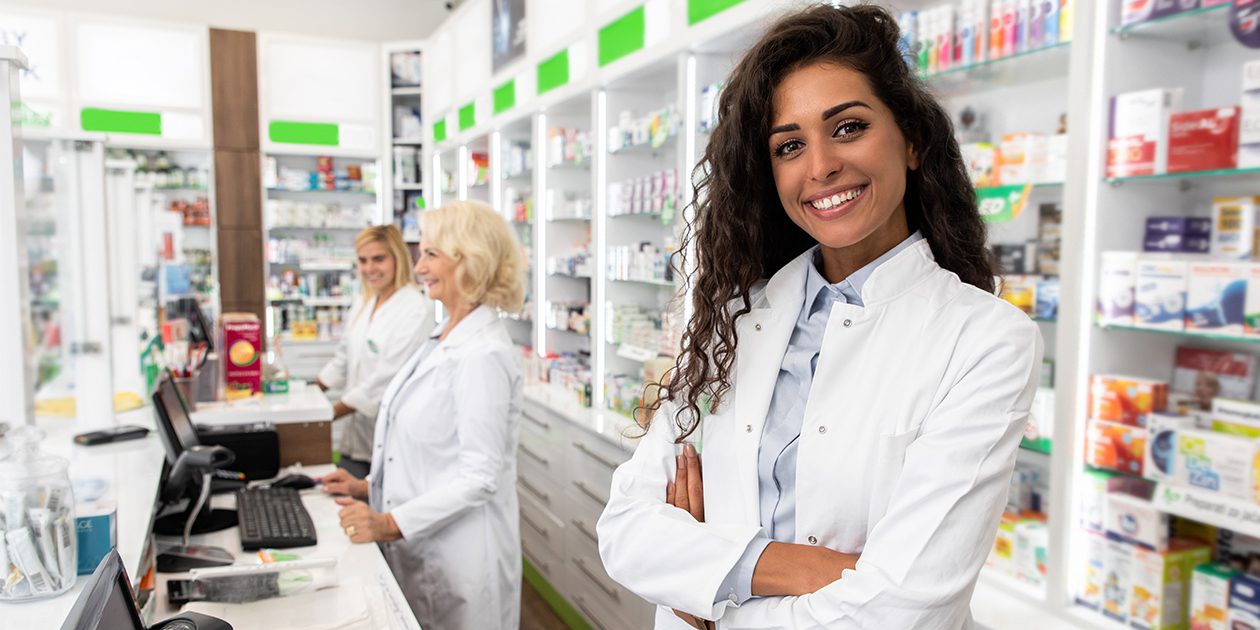 Female pharmacist smiles at camera
