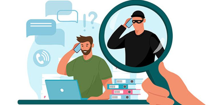 A man on a laptop with a robber next to him inside a magnifying glass.