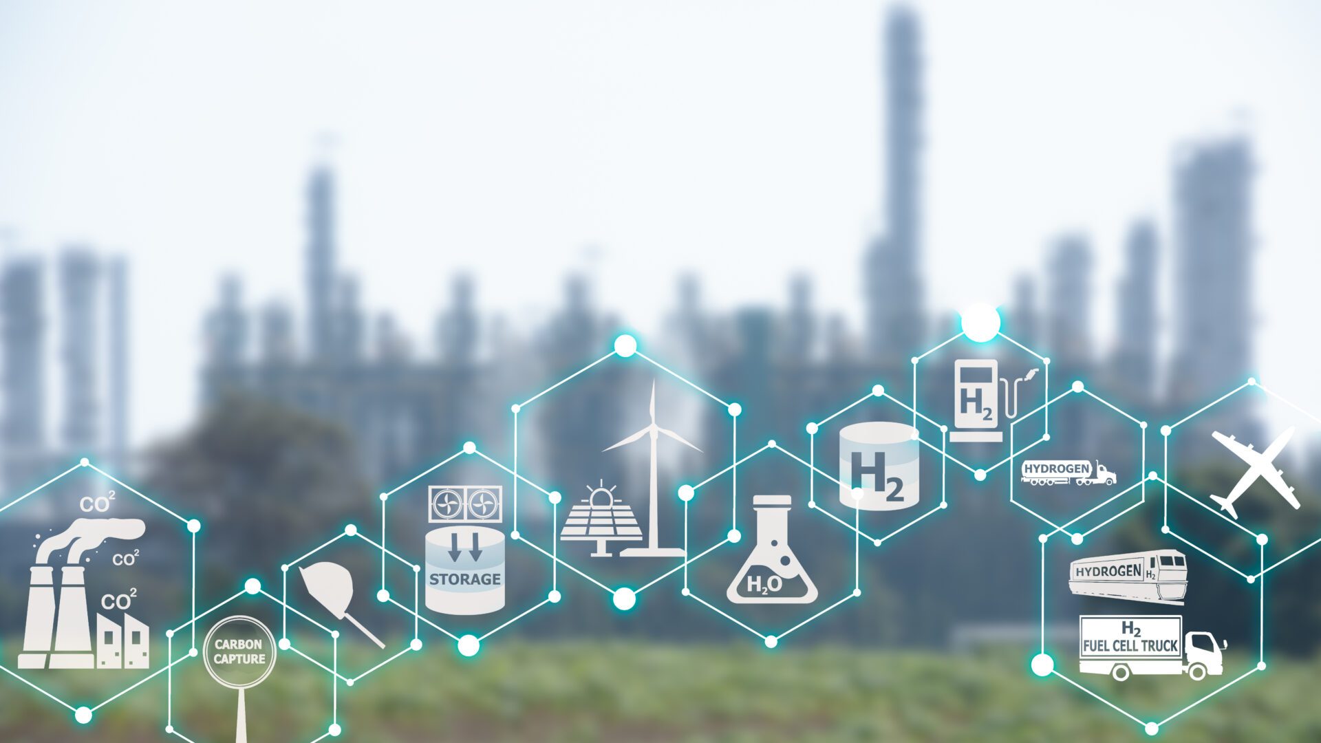A conceptual illustration showing the renewable energy ecosystem, overlaid on a blurred background of an industrial plant. Icons include CO₂ emissions, carbon capture, storage tanks, renewable energy sources like wind and solar, water electrolysis (H₂O), hydrogen fuel (H₂) containers, hydrogen fuel pumps, transport trucks, fuel cell vehicles, and an airplane.