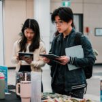 Two students providing feedback at a Feedback Station in the Library.