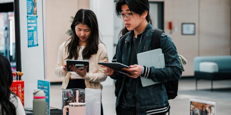 Two students providing feedback at a Feedback Station in the Library.