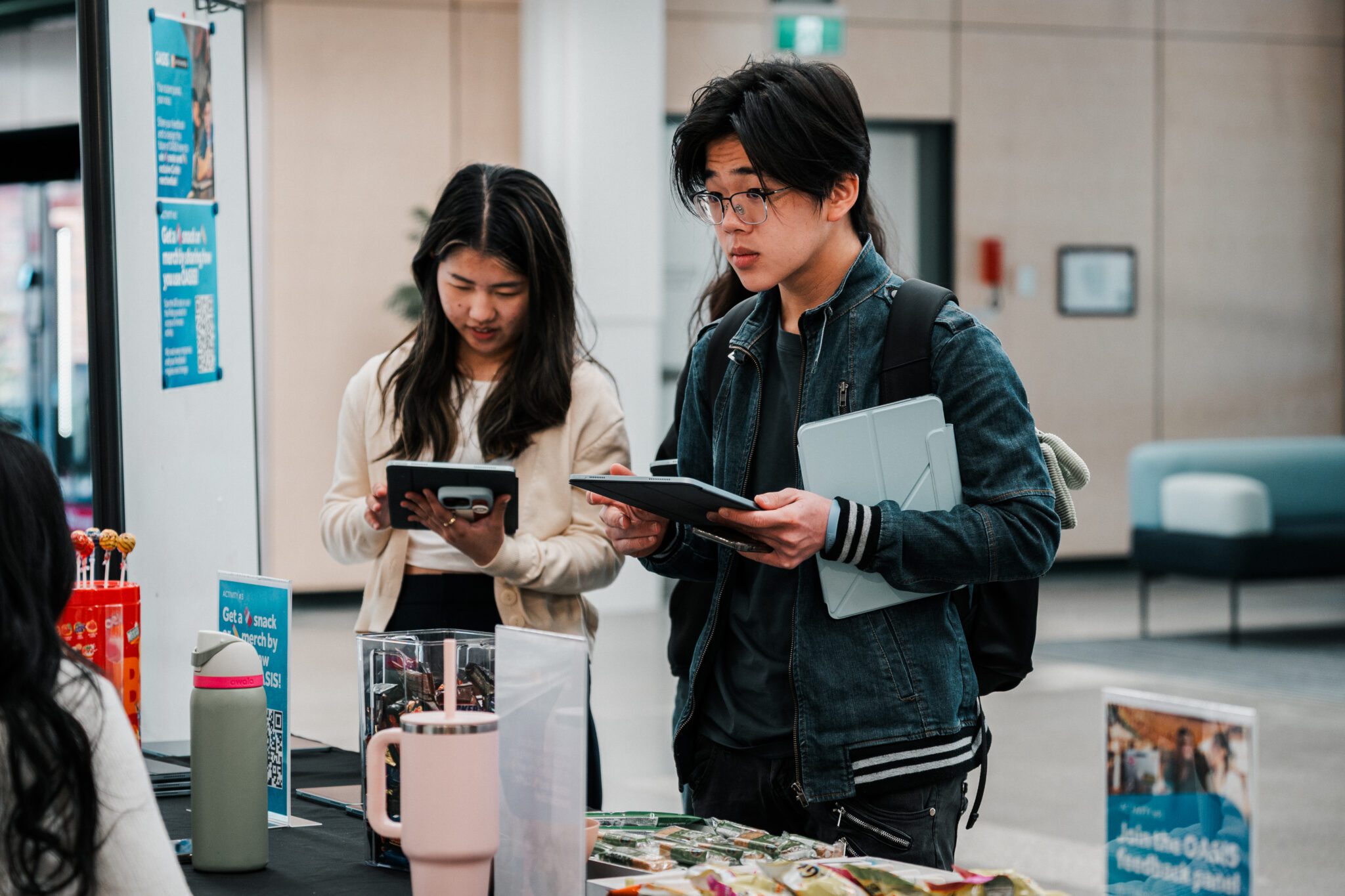 Two students providing feedback at a Feedback Station in the Library.