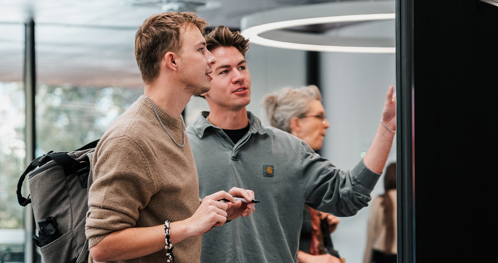 Two students giving feedback in the Curtin Library.