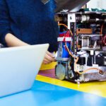 Two people working on robotics.