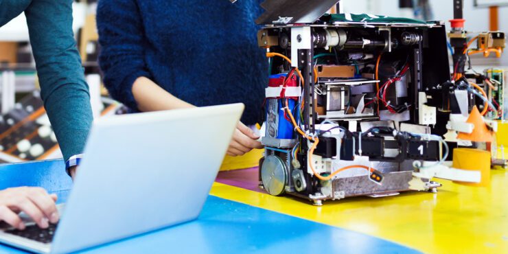 Two people working on robotics.