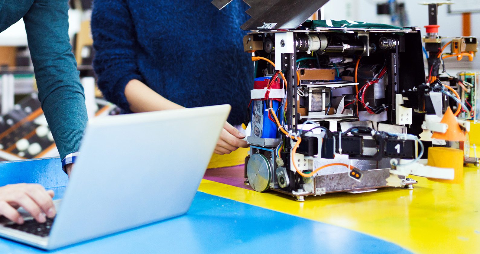 Two people working on robotics.