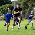 Image of two children sprinting alongside a Curtin Carnaby Coach