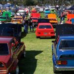 A line-up of classic cars parked on an oval.