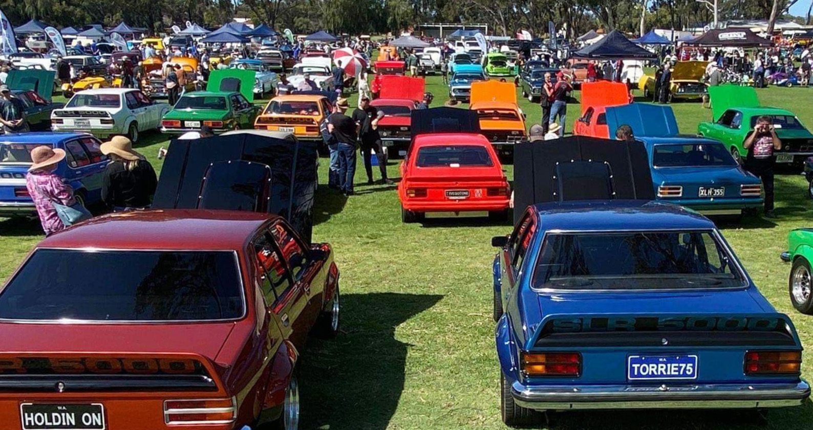 A line-up of classic cars parked on an oval.