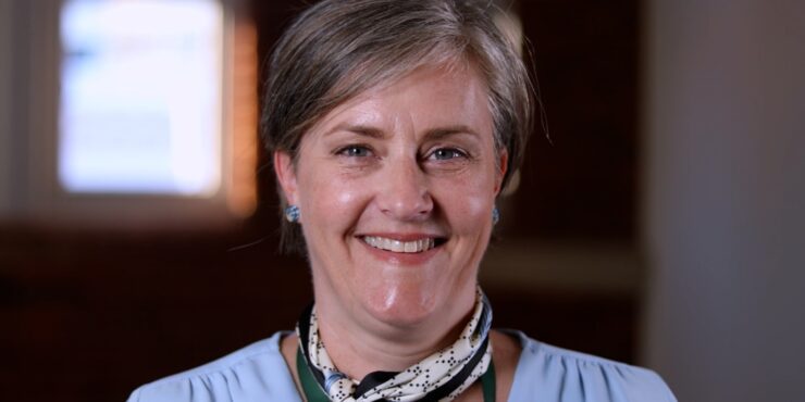 Headshot of a woman smiling warmly at the camera.