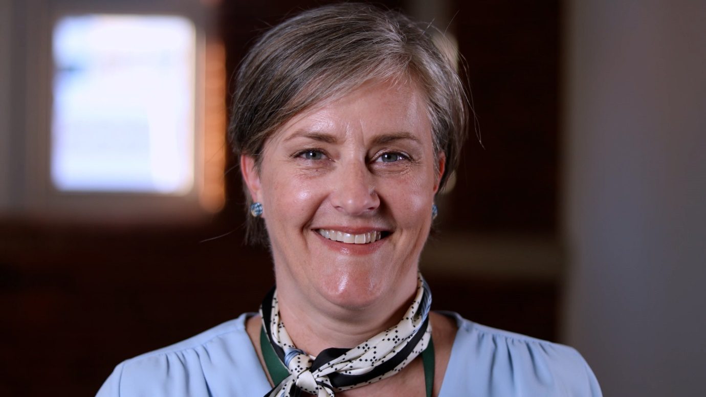 Headshot of a woman smiling warmly at the camera.
