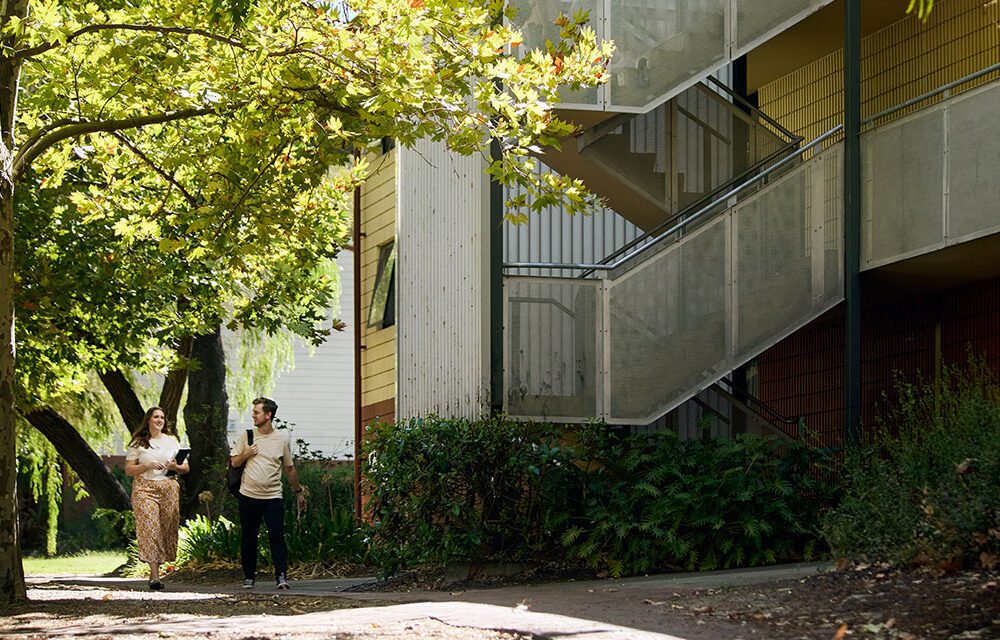 Curtin students walking outside accommodation.