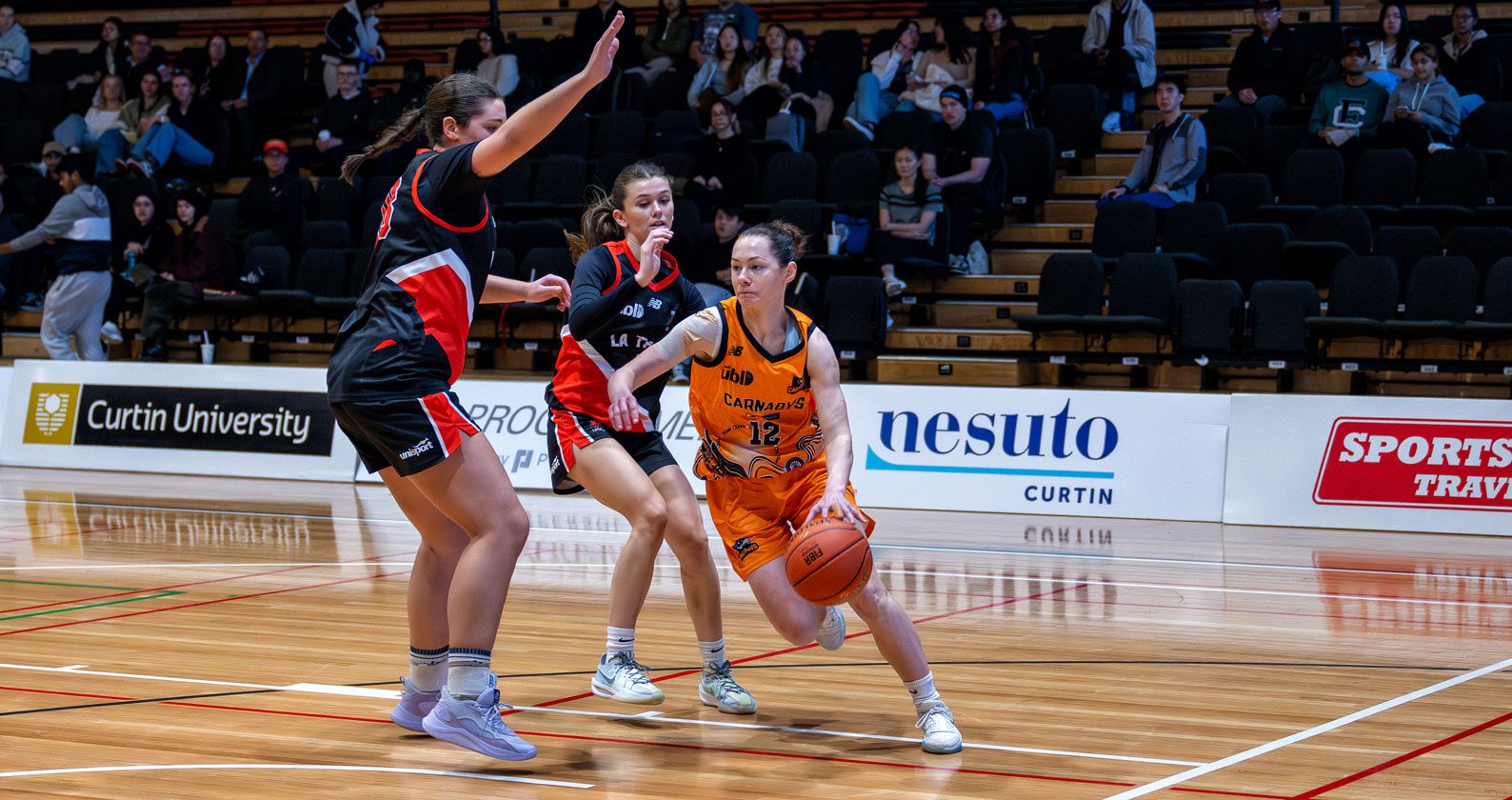 Student basketball players on the court.