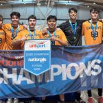 Curtin men’s futsal team holding a “2025 UniSport Nationals Division 2 Champions” banner.