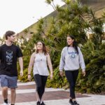 Three students walking towards Curtin Stadium