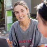 Students sitting outside talking.