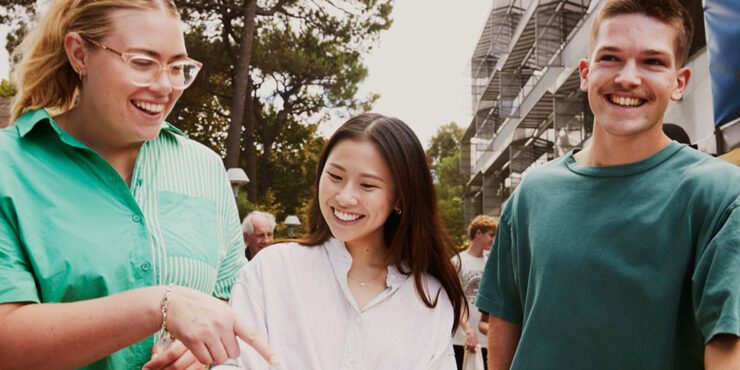 three students walking next to each other