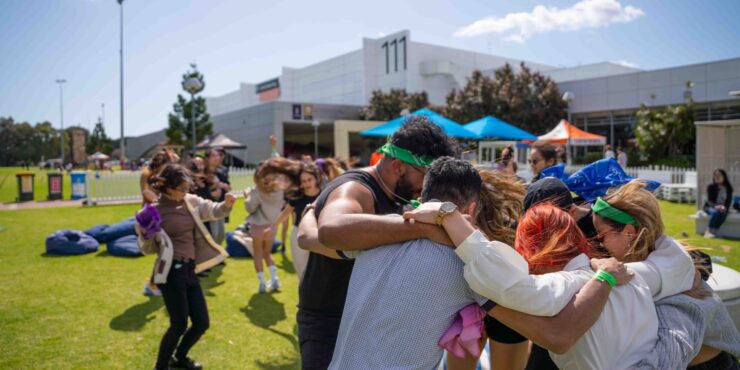 Group of students hugging at Curtin Carnival