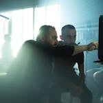 Film crew collaborating on set with cinematic lighting in Baghdad, Iraq, showcasing teamwork and creativity.