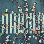 A busy pedestrian crosswalk overlaid with blue interconnecting lines.